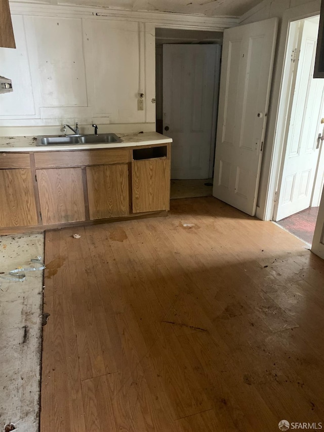 kitchen with light wood-type flooring and sink