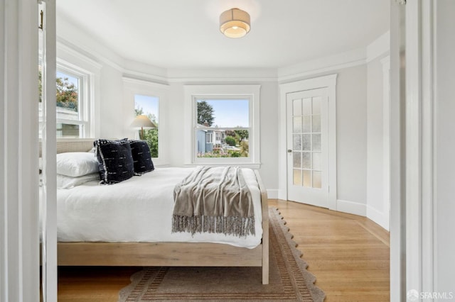 bedroom with baseboards and wood finished floors