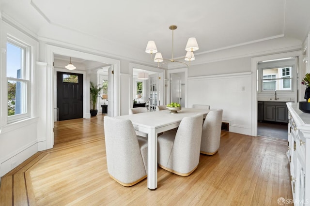 dining space with an inviting chandelier and light wood-style flooring