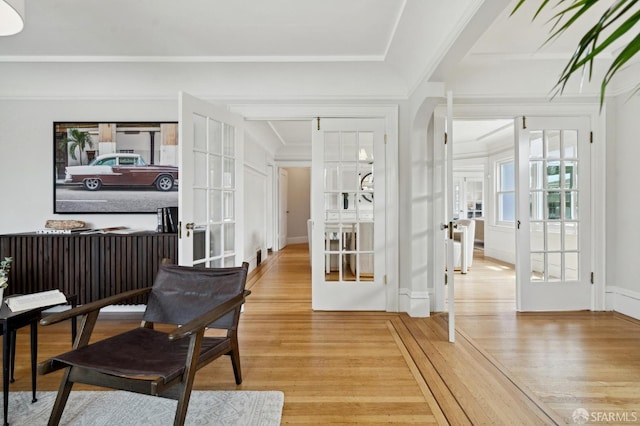 interior space with french doors, arched walkways, and light wood-style floors