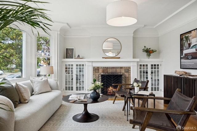 living area featuring ornamental molding and a tile fireplace