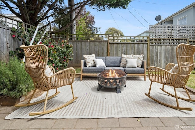 view of patio / terrace featuring fence, an outdoor living space with a fire pit, and a wooden deck