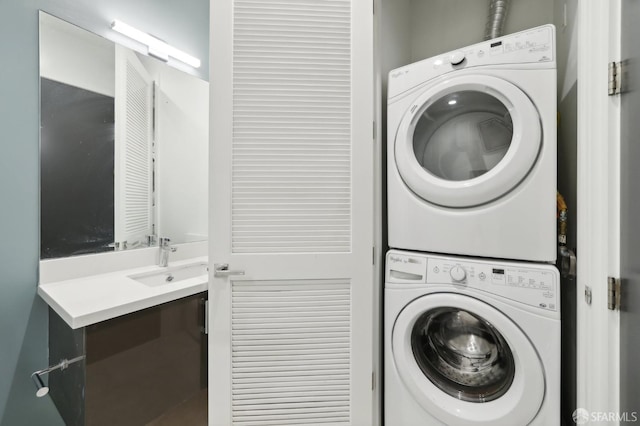 laundry area with sink and stacked washer / dryer