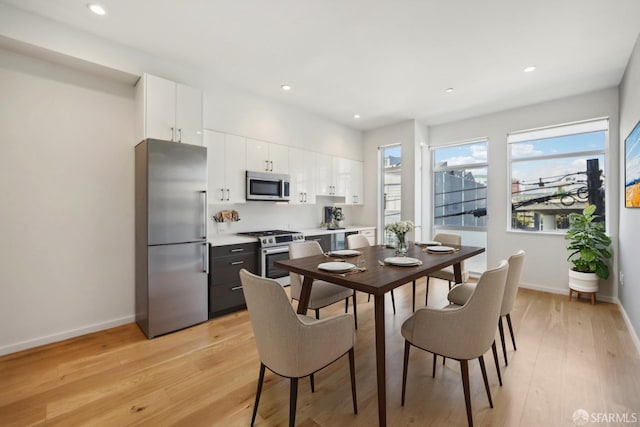 dining space with light hardwood / wood-style floors