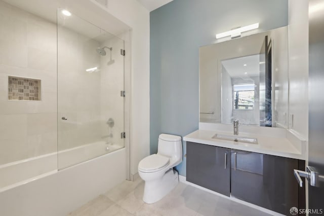 full bathroom with tile patterned floors, vanity, toilet, and tiled shower / bath combo