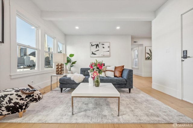 living room featuring beam ceiling, recessed lighting, wood finished floors, and baseboards