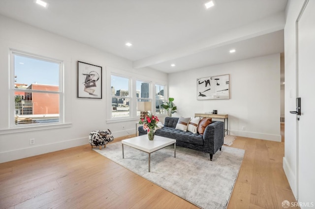 living room featuring beam ceiling, recessed lighting, baseboards, and light wood-type flooring