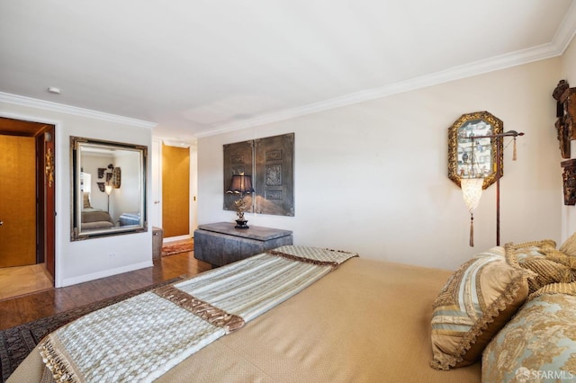 bedroom with crown molding and wood finished floors