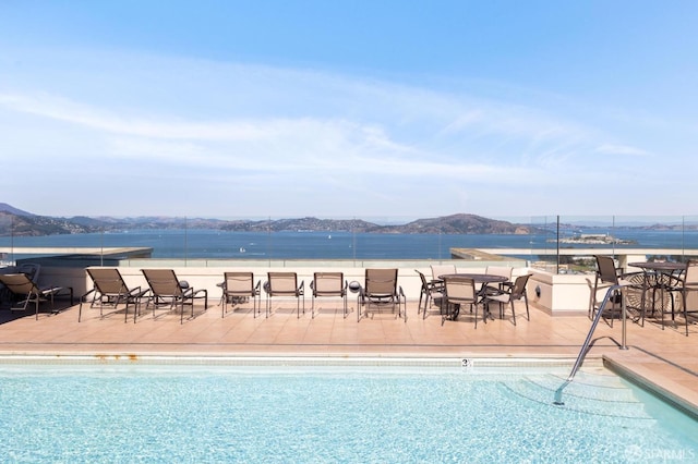 community pool featuring a patio and a mountain view