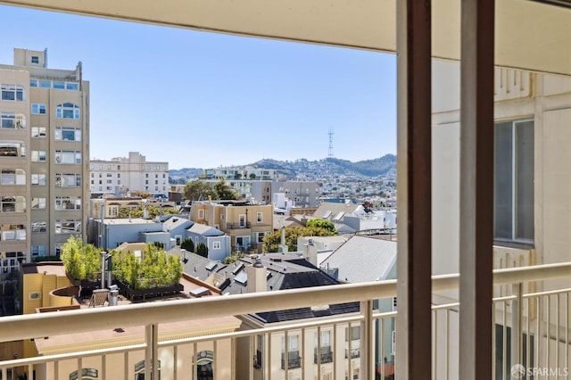 balcony with a view of city and a mountain view