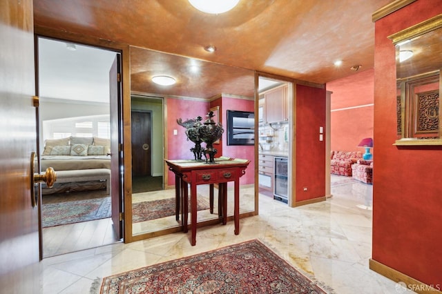 corridor with beverage cooler and baseboards