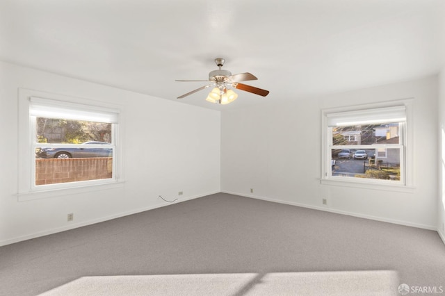 unfurnished room with ceiling fan and carpet flooring