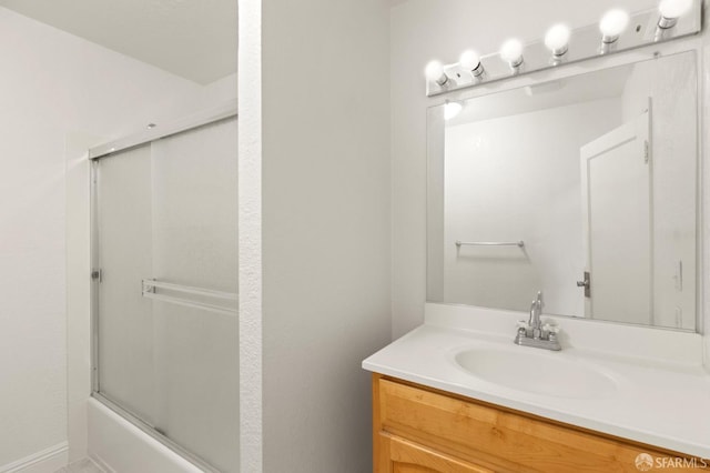 bathroom featuring vanity and combined bath / shower with glass door