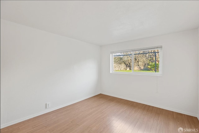 unfurnished room with light hardwood / wood-style floors