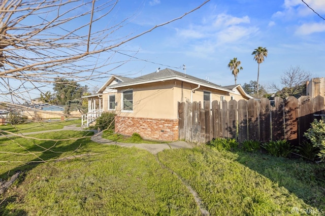 view of side of home featuring a yard