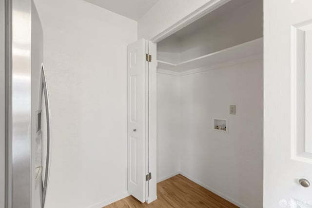 laundry area with washer hookup and light wood-type flooring