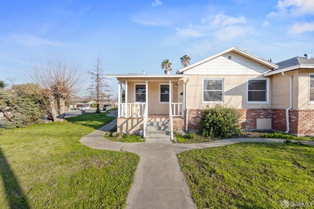 bungalow with a front lawn and a porch