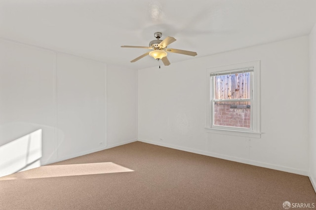 carpeted spare room with ceiling fan