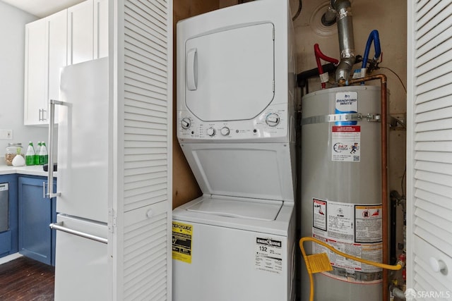 laundry area featuring stacked washer / drying machine and secured water heater