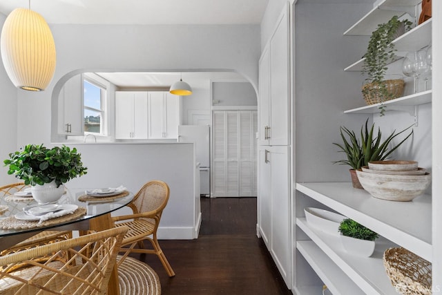 dining space with dark hardwood / wood-style floors