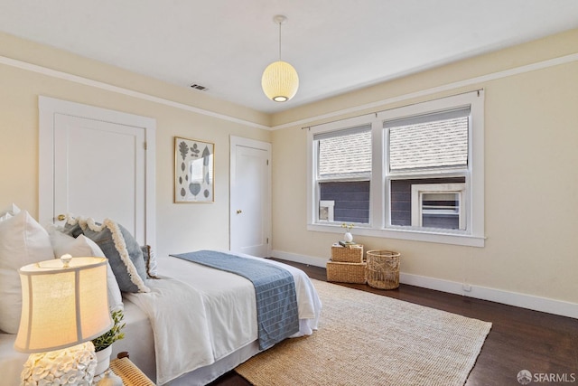 bedroom with dark hardwood / wood-style floors