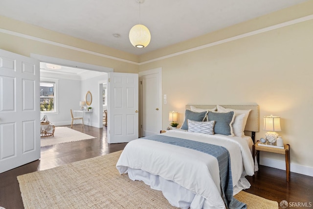 bedroom featuring dark wood-type flooring and ornamental molding