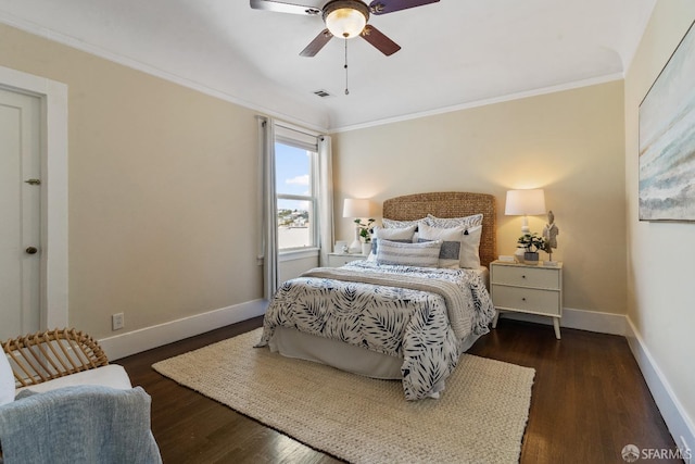 bedroom with crown molding, dark wood-type flooring, and ceiling fan