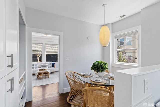 dining space with dark hardwood / wood-style flooring