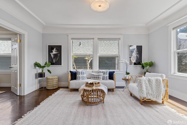 living room with crown molding and dark hardwood / wood-style flooring