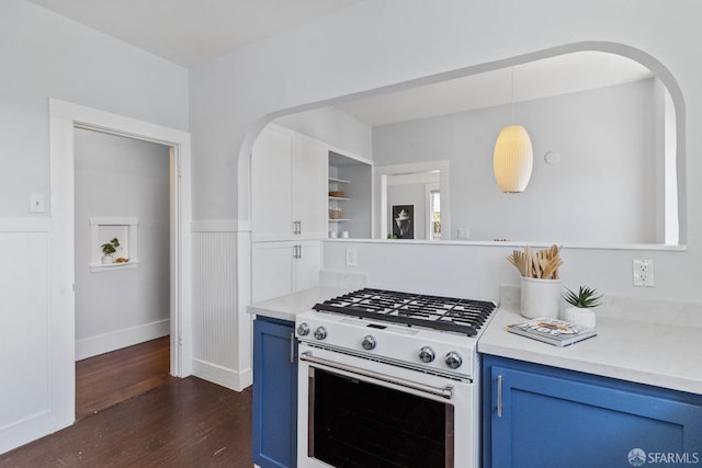 kitchen featuring pendant lighting, dark hardwood / wood-style floors, white range with gas stovetop, and blue cabinets