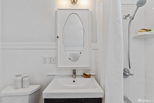 bathroom featuring toilet, vanity, and a shower with shower curtain