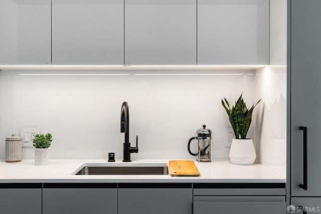 interior space with gray cabinetry and sink