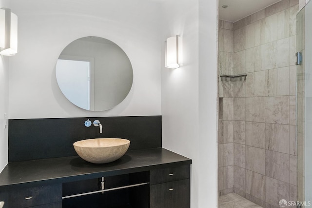 bathroom with vanity and tiled shower