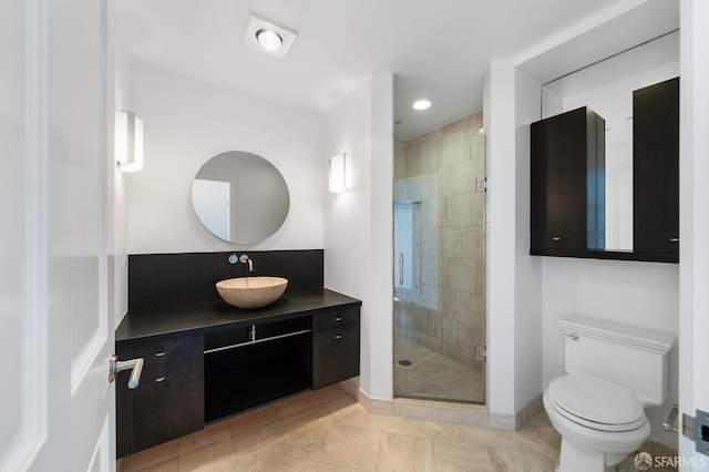 bathroom featuring tile patterned flooring, vanity, toilet, and an enclosed shower