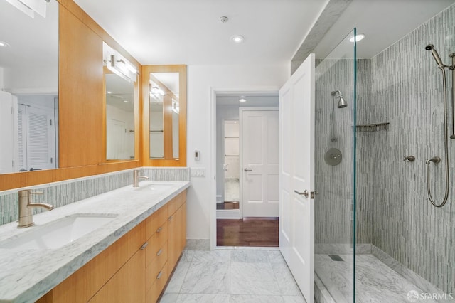 bathroom with walk in shower and vanity