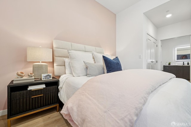 bedroom with a closet and light hardwood / wood-style flooring