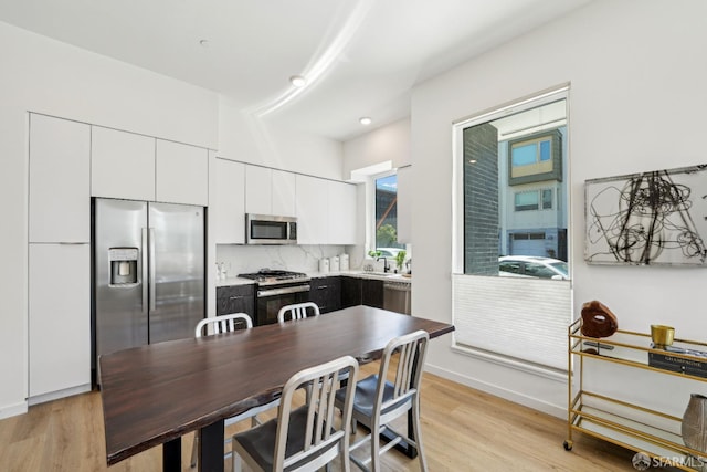 kitchen featuring white cabinetry, stainless steel appliances, light hardwood / wood-style flooring, and sink