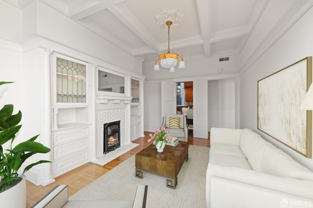 living room with beamed ceiling, coffered ceiling, and light hardwood / wood-style floors