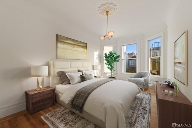 bedroom with an inviting chandelier and dark hardwood / wood-style floors