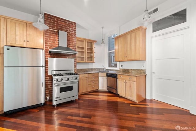 kitchen featuring pendant lighting, wall chimney range hood, stainless steel appliances, stone countertops, and light brown cabinets