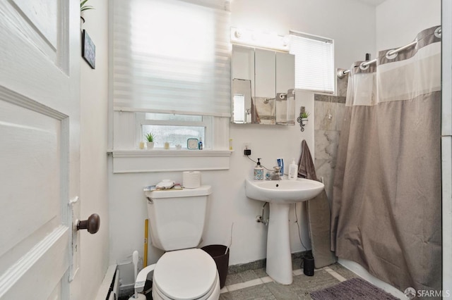 bathroom with walk in shower and toilet