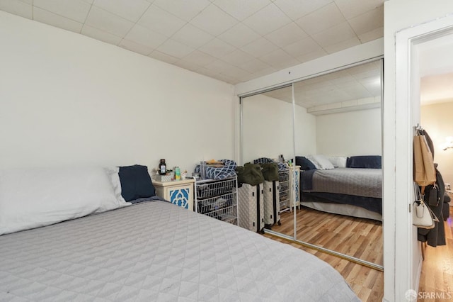 bedroom with hardwood / wood-style flooring and a closet