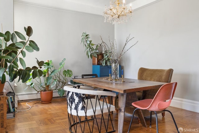 dining area featuring an inviting chandelier and light parquet floors