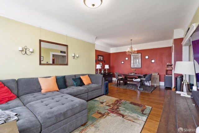 living room with dark hardwood / wood-style floors and a notable chandelier