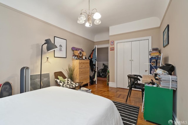 bedroom with an inviting chandelier, a closet, and parquet floors