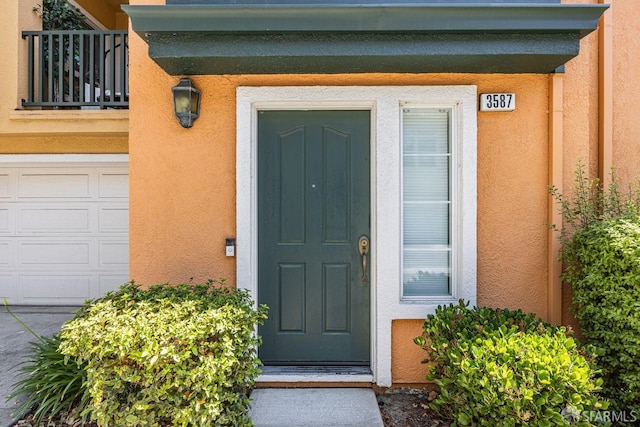 3587 Fitzsimmons Cmn, Fremont, CA 94538 - doorway to property featuring stucco siding and a balcony