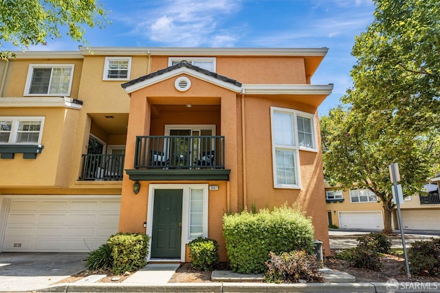 3587 Fitzsimmons Cmn, Fremont, CA 94538 - multi unit property with a balcony, stucco siding, and a garage