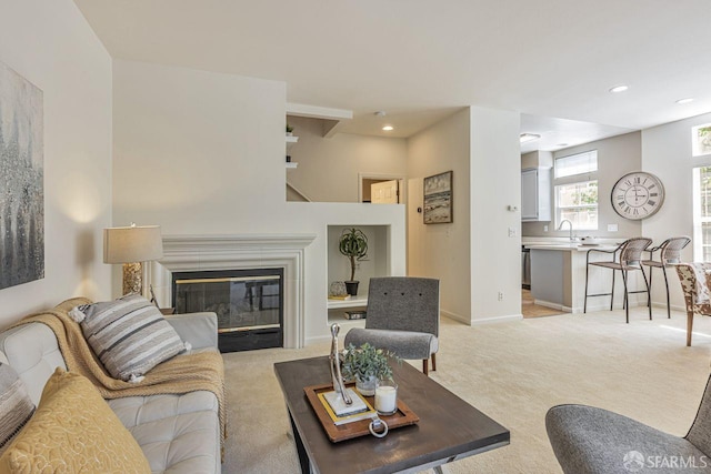 3587 Fitzsimmons Cmn, Fremont, CA 94538 - living area with light colored carpet, recessed lighting, and a glass covered fireplace