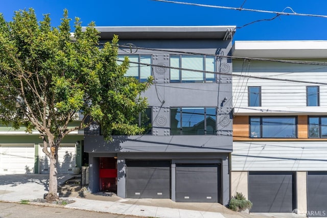 view of front of property featuring a garage and stucco siding