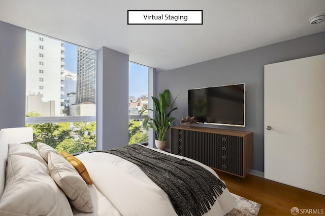 bedroom with expansive windows and wood-type flooring